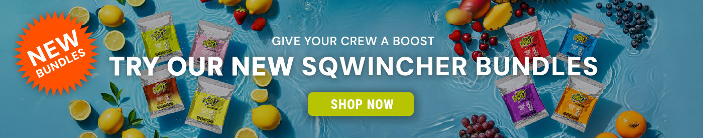 Sqwincher electrolyte drink mix packets displayed on water with lemons, limes, and strawberries around them. Text reads “Try Our New Sqwincher Bundles” with a Shop Now button.